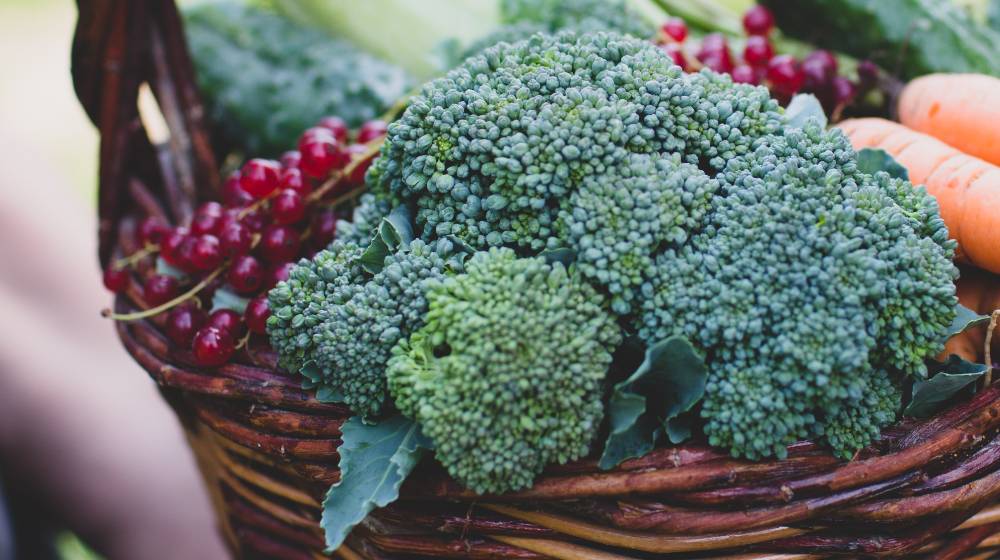 wooden basket full of vegetables and berries |