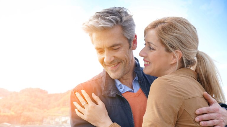 happy-mature-couple-hugging-outdoors-Understanding-Mental-Health-_-Its-Strong-Impact-on-the-Pace-of-Aging-feat-ss