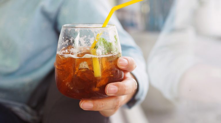 man-holding-cocktail-drink-close-up-How-Does-Exercise-Help-Reduce-Alcohol-Consumption