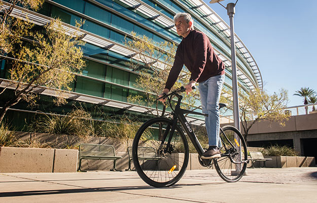 man-in-red-long-sleeve-shirt-and-blue-denim-jeans-riding-on-bicycle---Importance-of-Exercise-for-Muscle-and-Longevity---us-body