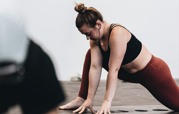 white-woman-does-yoga-poses-in-a-studio---What-Are-the-Symptoms-of-Sarcopenic-Obesity---as-body.jpg---us-body