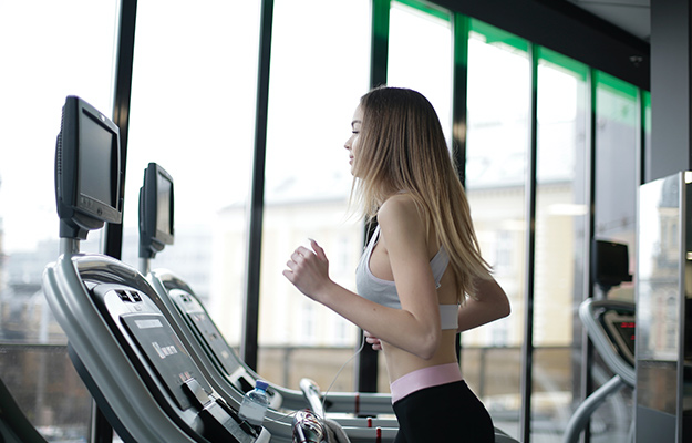 sporty-young-female-athlete-exercising-on-treadmill-in-modern-fitness-club-Ketogenic-Diet-Benefits