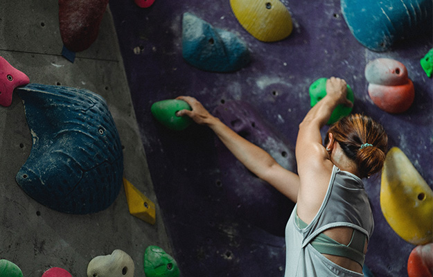 Woman-grabbing-grips-while-ascending-on-climbing-wall---Grip-Strength-and-Hospital-related-Variables---px-body