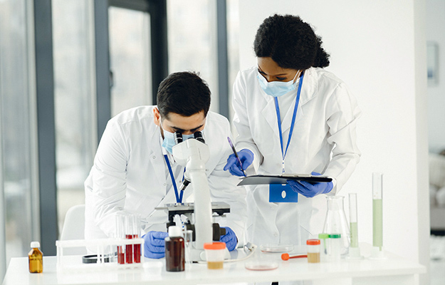 Man-Looking-at-the-Microscope-with-Woman-Assistant-What-Does-the-Finding-on-Plasmapheresis-Mean