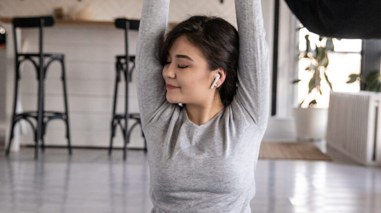 Ethnic-woman-in-earbuds-sitting-in-Lotus-pose-at-home-Exploring-DHH-B-(Dihydrohonokiol-B)-as-a-Natural-Treatment-for-Anxiety--px-feat