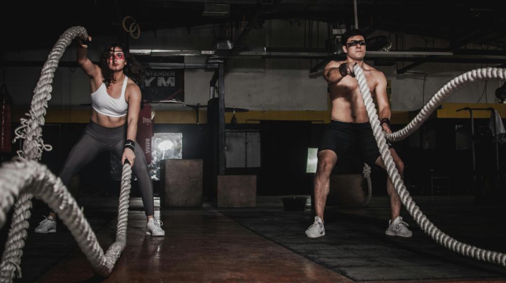 Man And Woman Holding Battle Ropes | HIIT Workouts for Beginners
